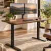 Electric Standing Desk — Alternate Walnut standing desk with black frame in a modern office