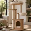 Modern Cat Tree — Editorial Multi-level wood and cream cat tree beside living room seating